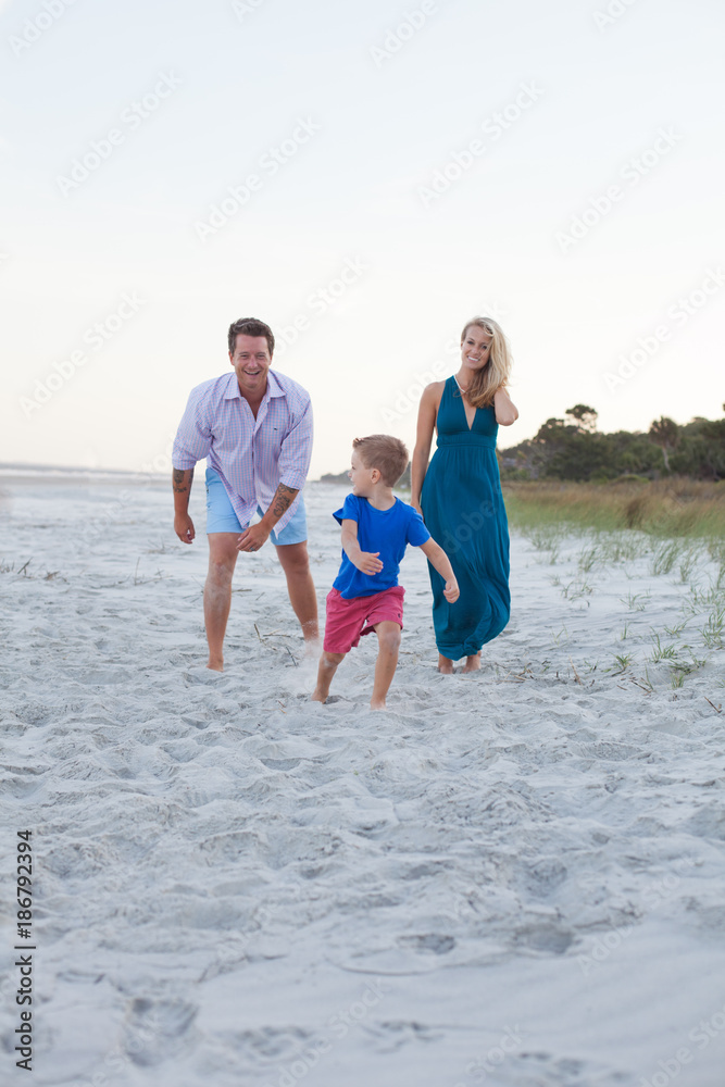 Family playing tag on the beach