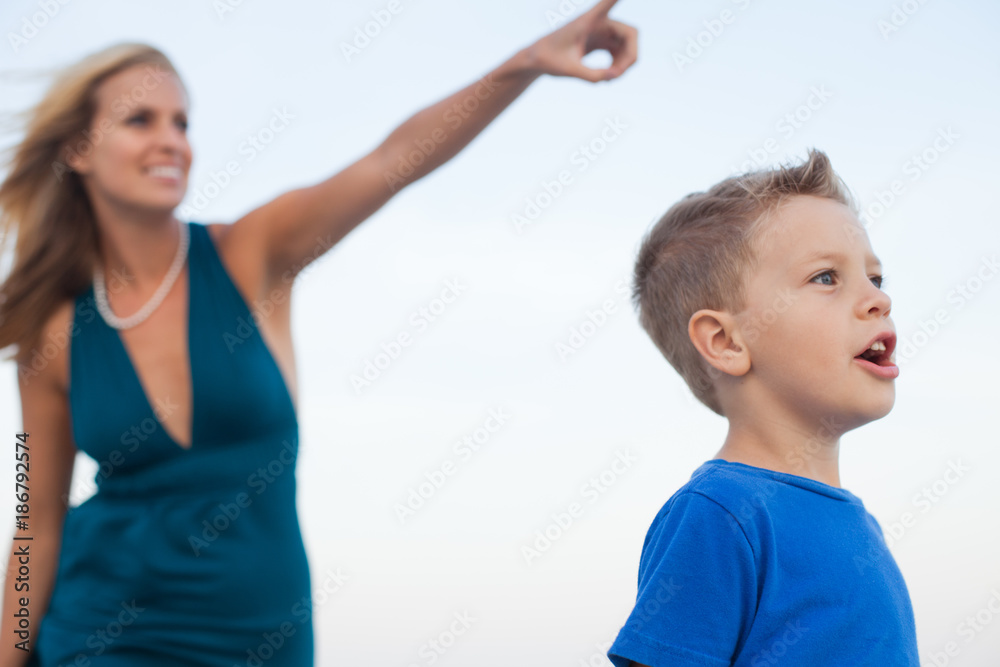 Mother pointing while son is excitedly looking Mother pointing while son is excitedly looking