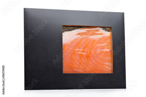 Black paper package with raw fresh salmon slices