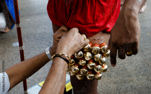 Devotee pierced hooks bells into legs during the Thaipusam festival at Serangoon Singapore	 photo