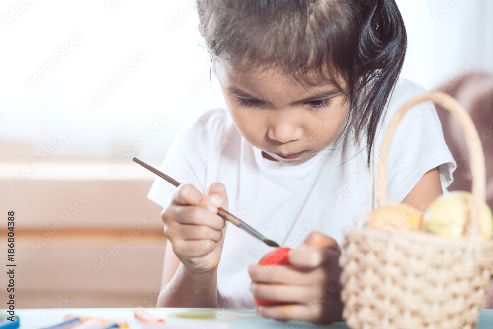 Happy asian child girl drawing and painting on easter egg prepare for easter day Happy asian child girl drawing and painting on easter egg prepare for easter day
