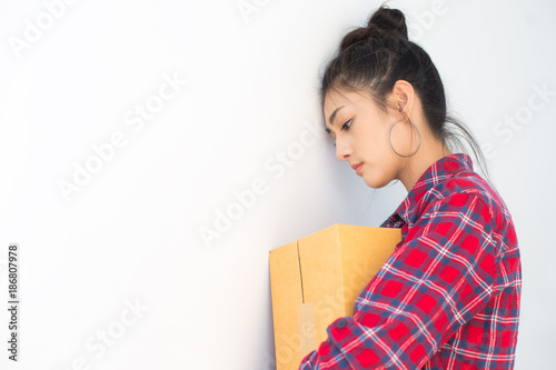 Asian woman holding box with stressful emotion. Young Owner Woman unsuccessful for Business Online, SME, Delivery Project. Woman with Online Business or SME Concept.