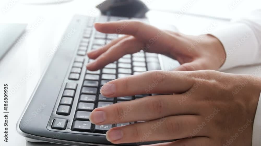 Closeup 4k pan footage of businesswoman typing message on computer keyboard