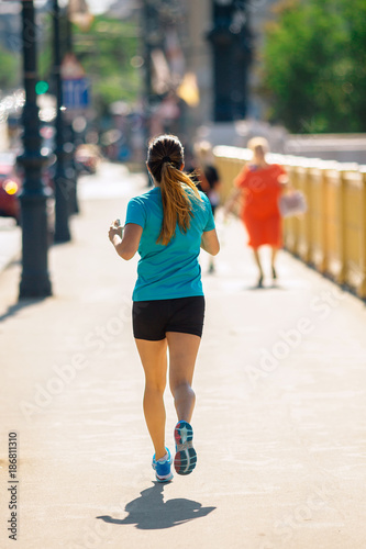 Girl Running or Jogging at the City Downtown