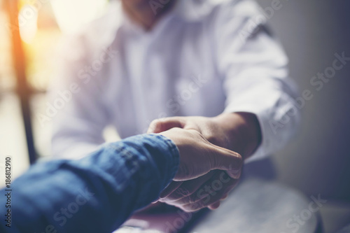Businessmen negotiate in a coffee shop. Hold hands and greet before the business talks comfortably