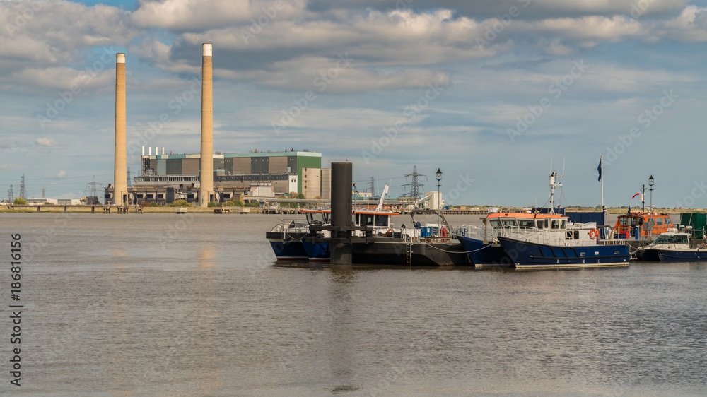 The shore of the River Thames in Gravesend, Kent, England, UK - with Tilbury Power Station in the background