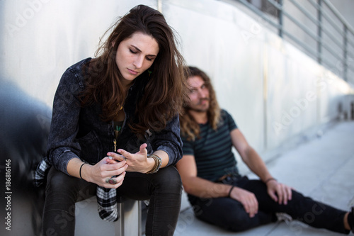 Φωτογραφία Worried sad unemployed people sitting on sidewalk feeling despair and hopeless