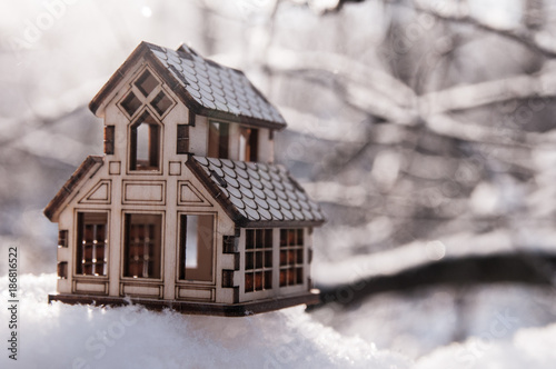 wooden toy house in the snow