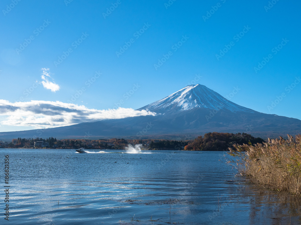 Fuji mountain with the boats and tourist are boating in the lake.