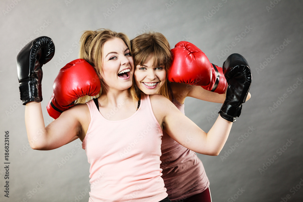 Two women friends wearing boxing gloves Two women friends wearing boxing gloves