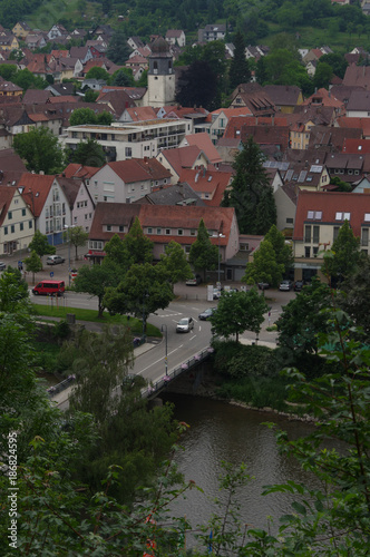 MUEHLACKER, ENZKREIS, GERMANY - JUNE 10, 2017: Residential tudor style house. view from a hill behinde the river Eny