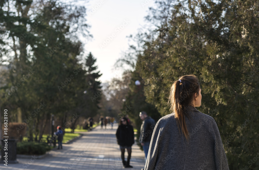 Girl walking in the Park in autumn time