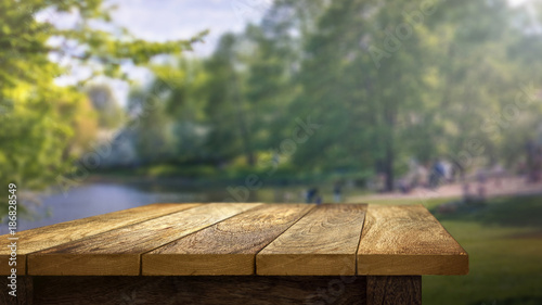 Wooden Table outside in park background photo