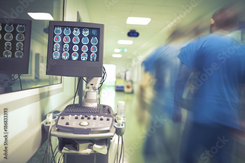 Male doctor hurrying in the hospital hallway to the emergency patient photo