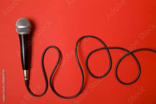 microphone and lead on a bright red background.
