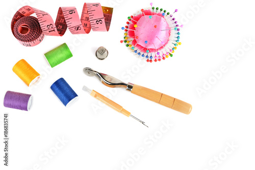 Composition with threads and sewing accessories isolated on white background. Flat lay, top view. Free space for text.