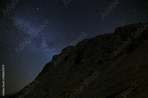 Night starry sky. The Milky Way in the background of a mountain range.