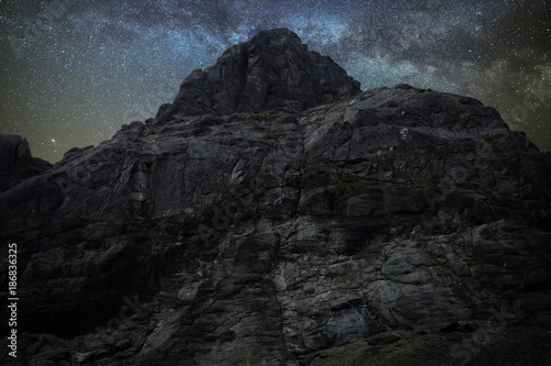 Night starry sky. Milky Way over a mountain peak.