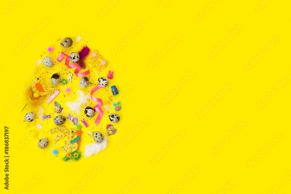 Quail eggs and decoration, in egg shape, on yellow background with copy space; easter background Quail eggs and decoration, in egg shape, on yellow background with copy space; easter background