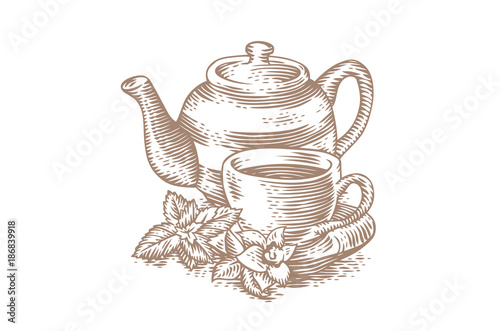 Cup of tea with teapot and greens