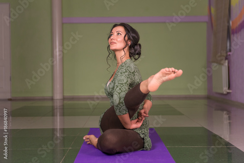 Girl working yoga stretches in a studio photo