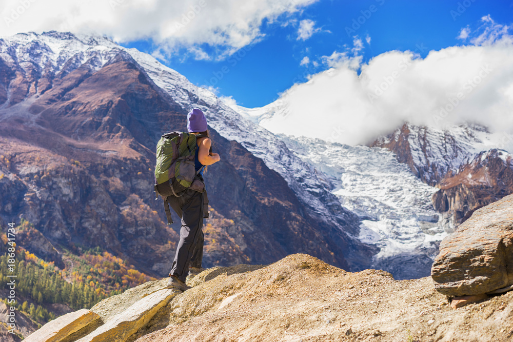 Travel concept. Hiker with backpack enjoing view on beautiful mountains.