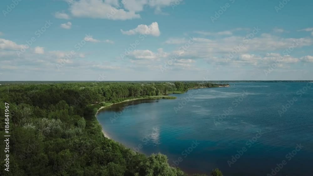 A wonderful flight to the beautiful forest near the wide river. Aerial view of pine forest in summer. A wonderful flight to the beautiful forest near the wide river. Aerial view of pine forest in summer.