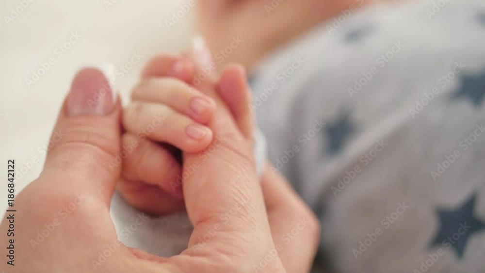 Mother and her newborn baby, parent holding newborns hand, happy mother and baby together. Maternity and parenthood concept. Mother and her newborn baby, parent holding newborns hand, happy mother and baby together. Maternity and parenthood concept.