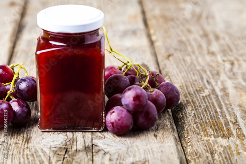 Jar with jam and grapes