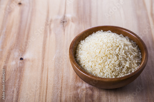 Raw rice in a wooden bowl