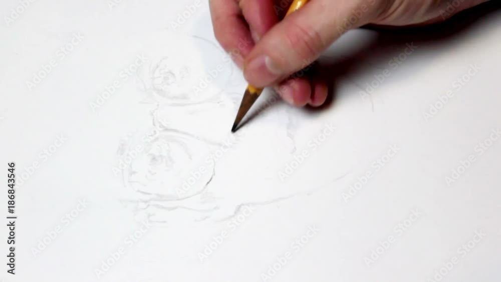 A man drawing a face of a person. A man drawing a face of a person.