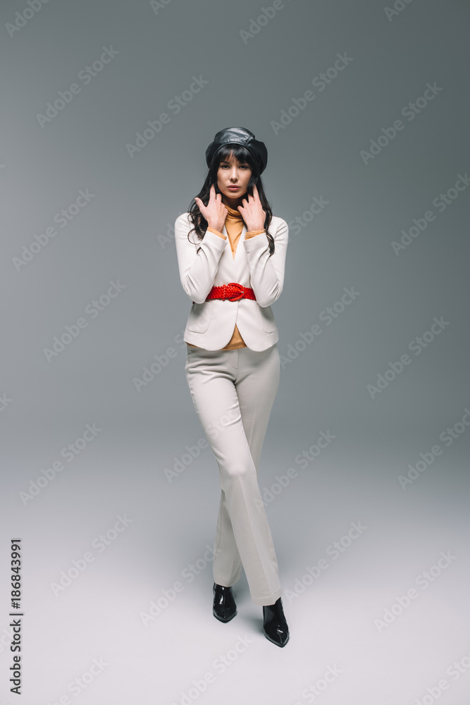 beautiful brunette woman in white suit posing on gray beautiful brunette woman in white suit posing on gray