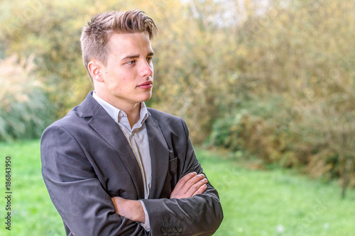 Young busienssman standing outdoors