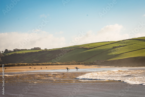 Surfers leaving the water on Winters day.