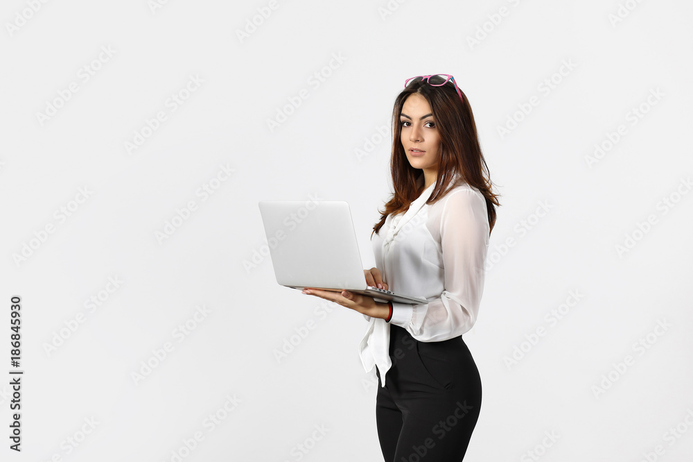 Smiling young business woman using laptop