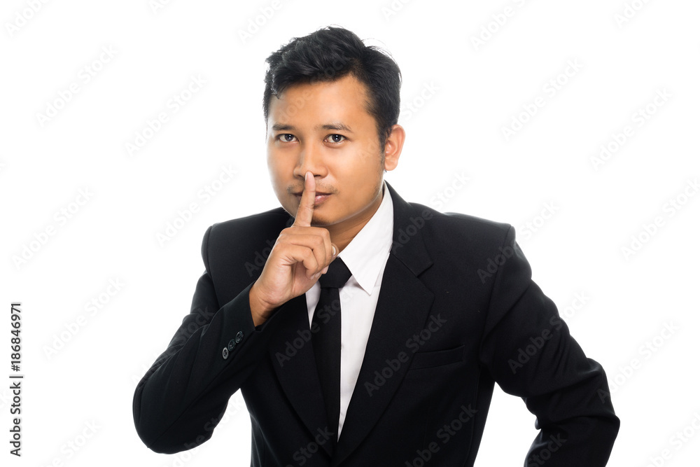 Portrait of an asian businessman smiling and showing sign hands for shut up. Isolated on white background Portrait of an asian businessman smiling and showing sign hands for shut up. Isolated on white background