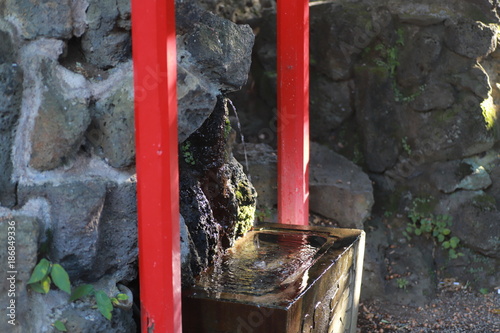 Temizuya is a Shinto water ablution pavilion for a ceremonial purification rite known as temizu. photo