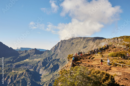 Piton Maido, La Reunion Island, France - August 15, 2017: Tourists on the Maido lookout overlooking Cirque of Mafate, listed as World Heritage by UNESCO, La Reunion Island, France.