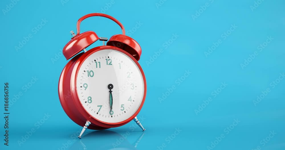 Red metal classic alarm clock time lapse copy space blue background