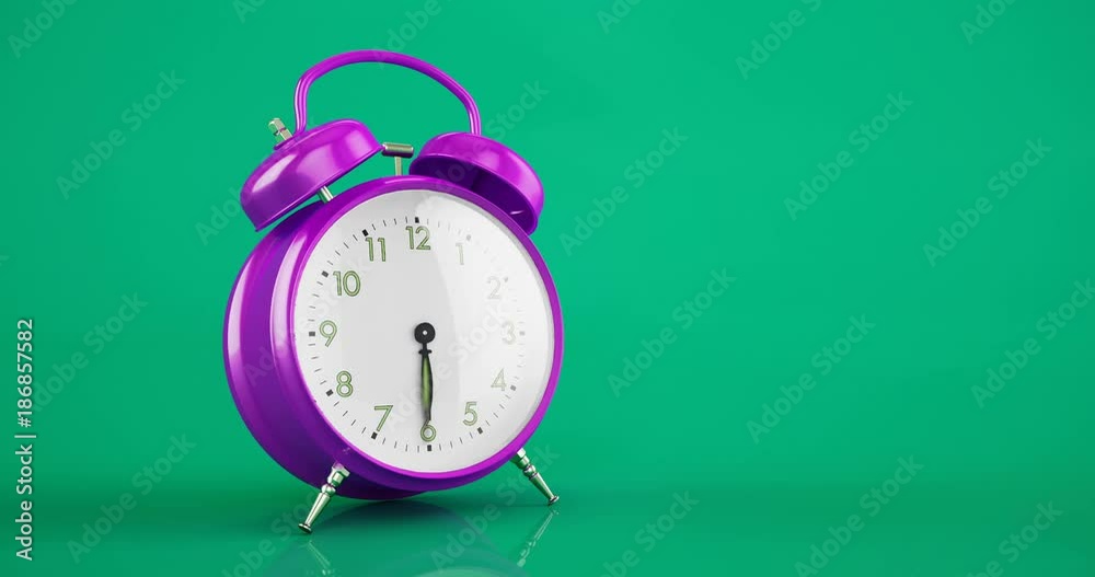 Metal violet vintage alarm clock time lapse copy space green background