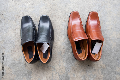 New black shoe and brown shoe made of leather