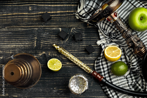 Arabic hookah with a tobacco flavor of a mixture of citruses and apple photo