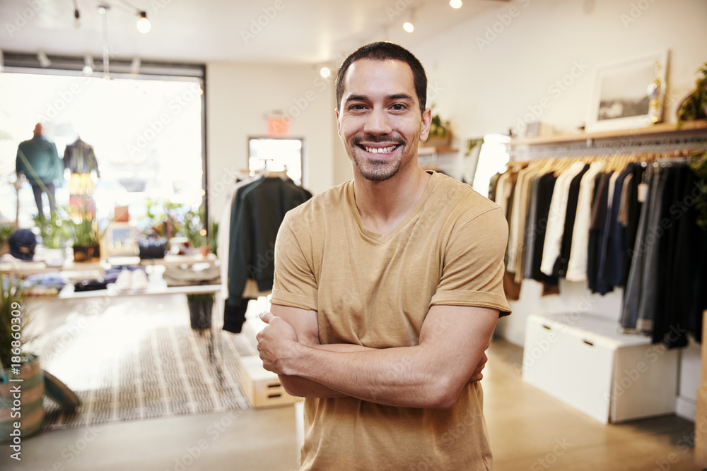 Young Hispanic man smiling to camera in a clothes shop Young Hispanic man smiling to camera in a clothes shop