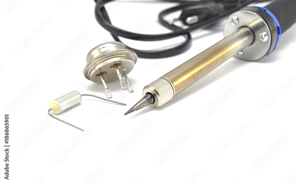 Radio components and electric soldering iron on white background close-up Radio components and electric soldering iron on white background close-up
