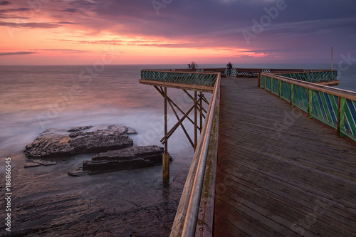 Sunrise over the Indian ocean from the wooden deck at the East London aquarium in South Africa photo