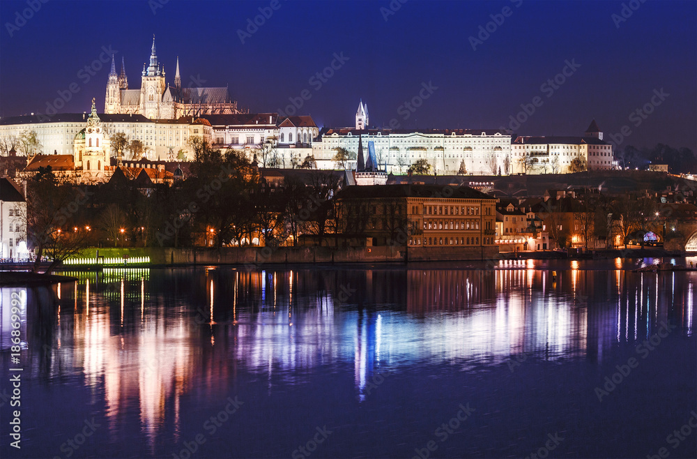 Classic evening view of the Vltava River and the historic center of Prague with a majestic castle