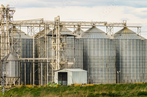 Agricultural grain dryer complex close-up. Modern granary with weighing station. © nskyr2