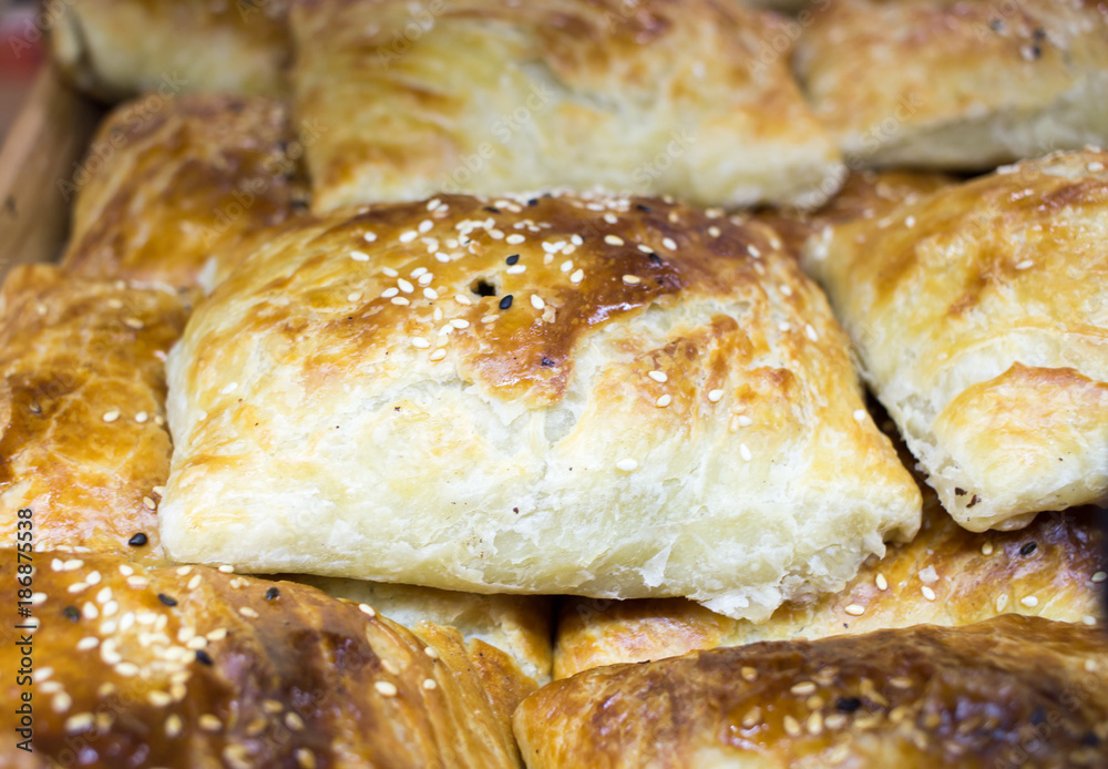 patties of a triangular shape in Uzbek and Tajik cuisines, often with a filling of chopped meat