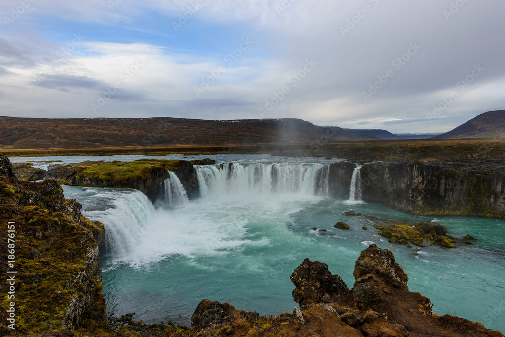 Godafoss, waterfall of the gods, is one of the most spectacular waterfalls in Iceland. Amazing landscape at sunrise. Popular tourist attraction. Unusual and picturesque scene.