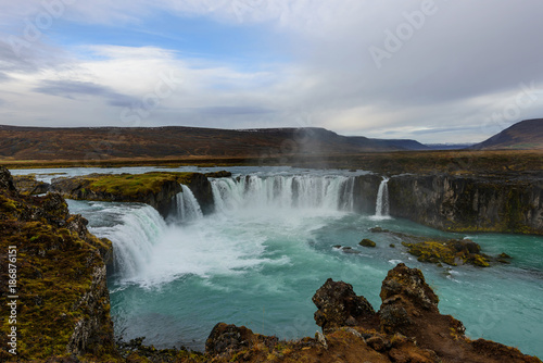 Godafoss, waterfall of the gods, is one of the most spectacular waterfalls in Iceland. Amazing landscape at sunrise. Popular tourist attraction. Unusual and picturesque scene.